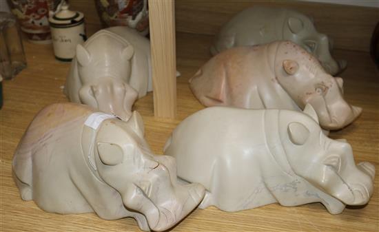 A set of five figures of hippos